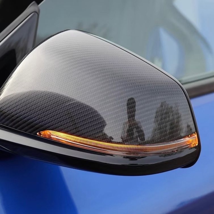 Close-up of a carbon-fiber mirror cap after detailing